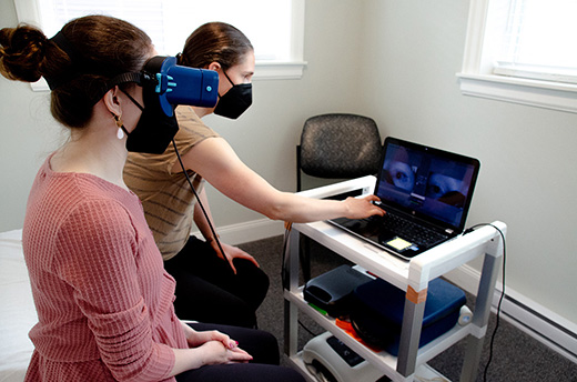 Therapist administering vestibular rehabilitation therapy on a client